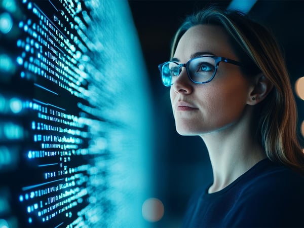 female-tech-professional-studying-data-on-screen